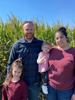 Bella with her husband, Pat, and their daughters, Stella and Charlotte